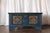 Description: This hand-painted European pine blanket chest features vibrant folk art floral panels and a rich blue ground,...