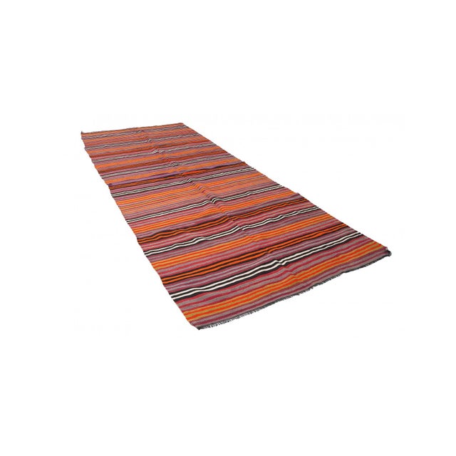 Handwoven vintage striped decorative kilim rug from Denizli region of Turkey. Approximately 50-60 years old. In very good...