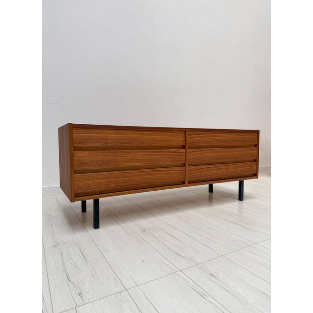 Beautiful vintage chest of drawers from the 1960s with clean Mid-Century Modern lines and elegant walnut veneer. The piece...