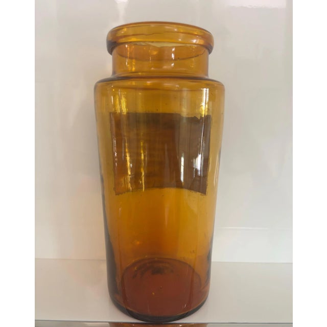 This large amber apothecary jar brings warmth and vintage charm to any interior. Hand-blown in thick glass, this authentic...
