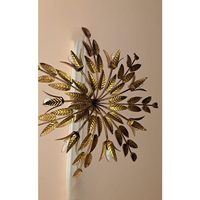 Vintage ceiling lamp by Ferro Art, made in Spain around the 1950s or 60s. It's a "Sunburst" style piece, featuring a...