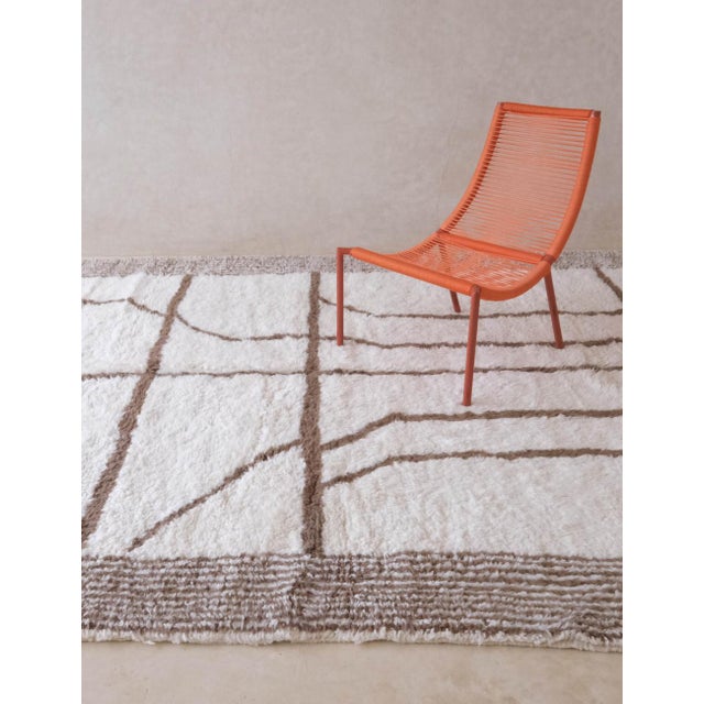 Bring a playful touch of Moroccan charm to your space with this Ivory Moroccan Rug. Its soft ivory wool base feels cozy...