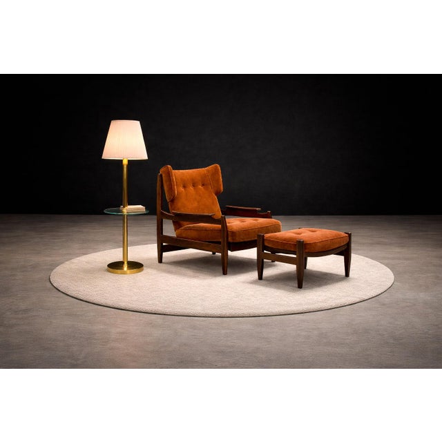 A commanding yet deeply inviting lounge chair and ottoman by Alexandre Rapoport, this set exemplifies the sculptural...