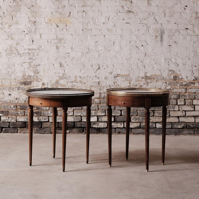 Early 20th-century Louis XVI-style bouillotte table crafted from mahogany with a white marble top. Originally used for...