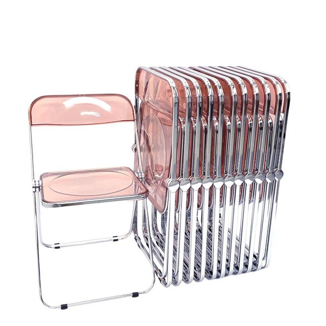 Set of 12 original and signed "plia" pink acrylic glass folding chairs. Nos (new old stock) this fantastic set was...