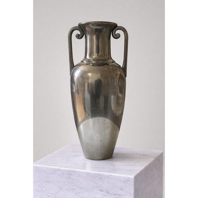 A refined Swedish Art Deco pewter amphora vase, designed for Svenskt Tenn in the 1930s. This elegant piece features a...