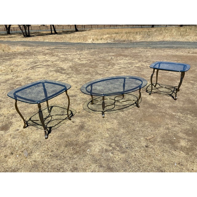 Vintage Hollywood Regency Style Oval Glass-Top Coffee Table and Side Table Set exudes elegance and sophistication. Made in...