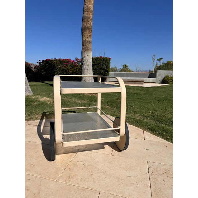 This is a beautiful, functional bar cart circa 1980’s by Brown Jordan with original tempered glass shelves and oversized...