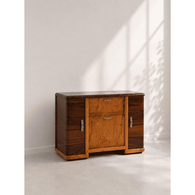 A refined Art Deco wooden bar cabinet, featuring an elegant opening system that reveals its fully equipped and...