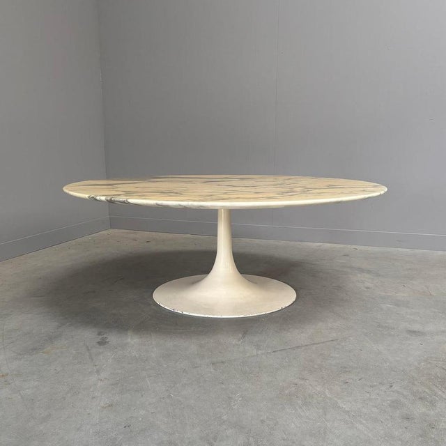 Mid century coffee table from the 1960s with tulip base. Carrara marble table top with steel base. Table is in good...