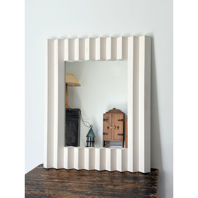 A vintage French mirror with a moulded design frame in plaster relief. A rare find. This incredible post modern piece is a...