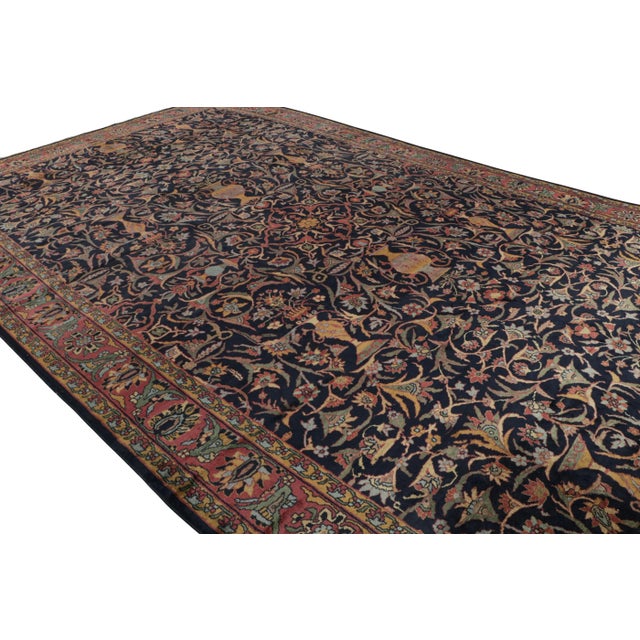 Hand-knotted in wool, this 12x19 oversized Antique Shahrestan rug features a play of all-over and medallion style, with...