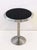 A fine French round bistro table of chromed steel from the Art Deco period, featuring a circular graduated top with black...