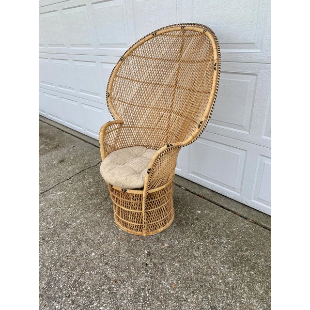 A gorgeous and iconic mid-century modern Bohemian Emanuelle peacock chair Circa 1970s Woven rattan and wicker, with a...