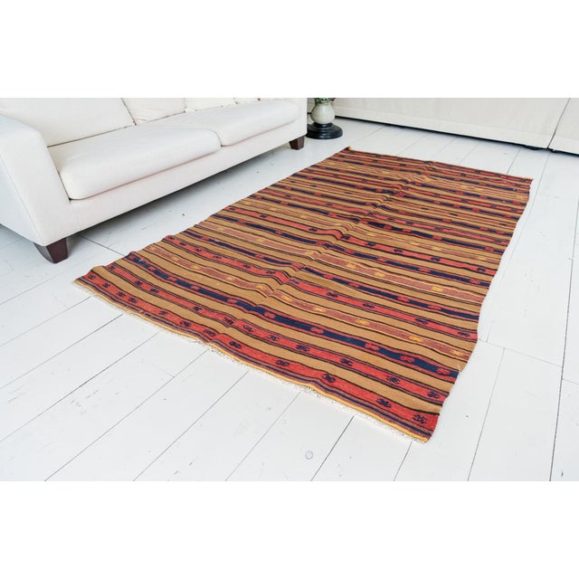 This is a vintage Turkish Oushak rug from the Mid 20th Century. The piece was hand-knotted.