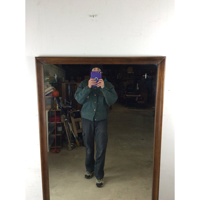 This mid century modern mountable mirror features hardwood construction, original walnut finish, beveled wood frame, and...