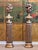 A stylish pair of late 18th or early 19th century Continental carved giltwood columns, each topped with a flame finial...