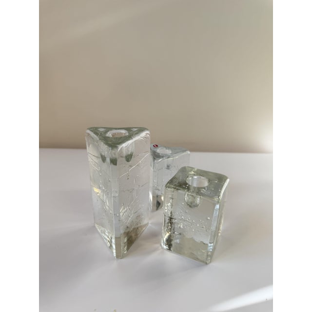 A set of three "Arkipelago" candleholders designed by Timo Sarpaneva for Iittala, Finland, around 1980. Cast in clear...