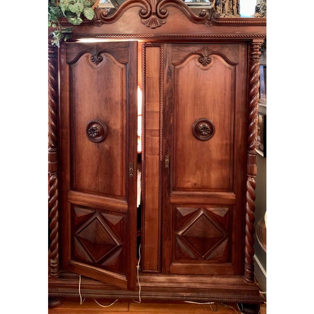 Spanish, heavily carved armoire Left side opens to 3 re-positional shelves Right side opens to hanging storage with a full...