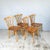 A set of four Candlestick Chiltern dining chairs by Ercol. Eight beech spindles rise from each seat in four crossing pairs...