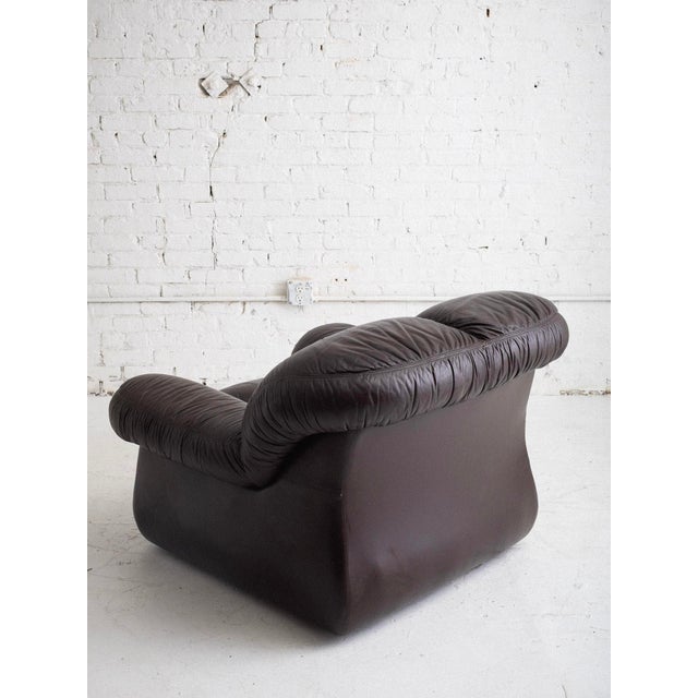 Italian club chair in original espresso brown leather upholstery, 1970s. Overstuffed, tufted silhouette. Pair available,...