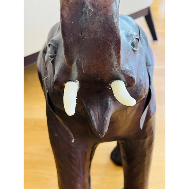 Meet Ellie! A wonderfully detailed, large, leather wrapped, trunks up, elephant figurine with piercing blue marble eyes....