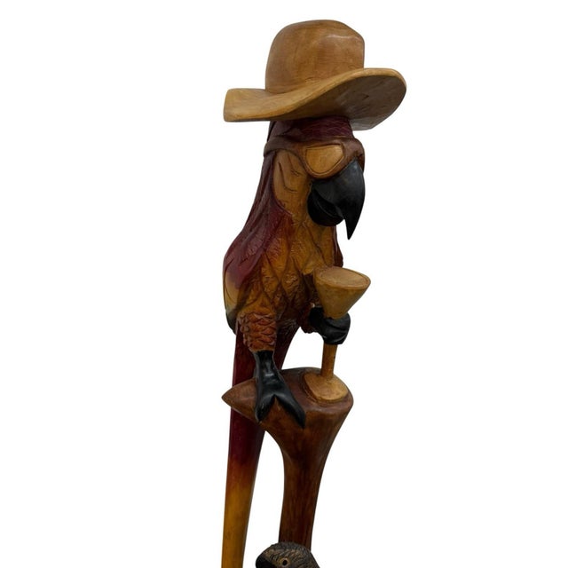 This vintage folk art wood sculpture of a parrot is a unique and handmade piece, measuring 41 inches in height. The...