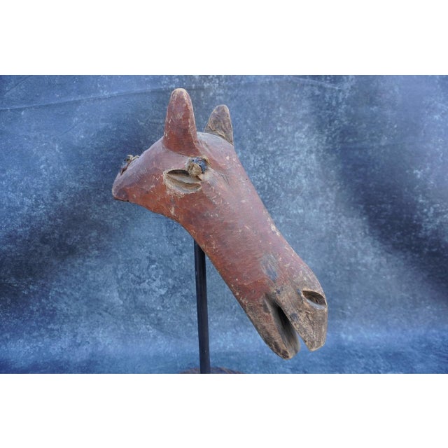 Really striking. It has life. Origin unknown. It stands (on its stand) 24 3/4" high x 18" wide and 11" deep.