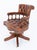 A fine and comfortable mahogany captains chair, raised on a shaped revolving base fitted with brass castors, combining...
