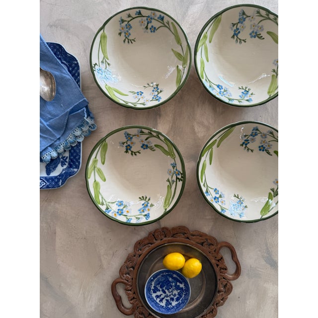 Beautiful set of four vintage bowls by Franciscan in the Forget Me Not pattern, featuring delicate hand-painted blue...
