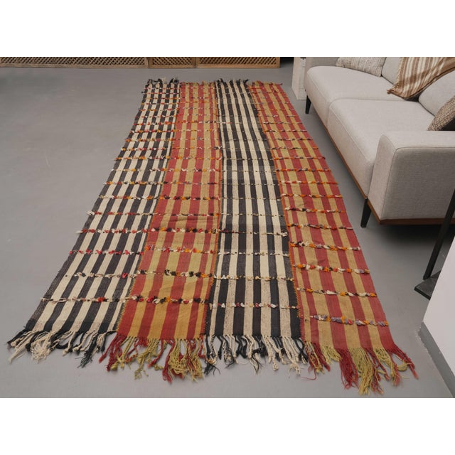 Vintage Hand-Knotted runner rug is a semi-antique vintage area rug. The '70s Eastern region of Anatolia's unique rug is...