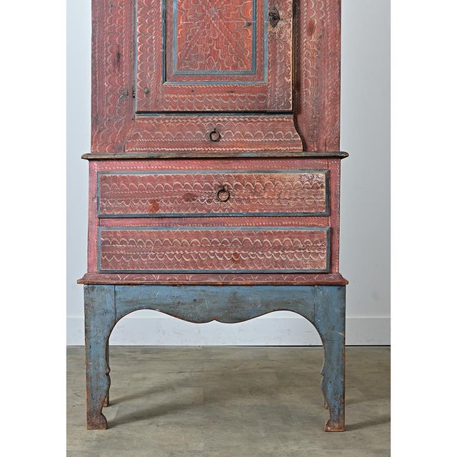 This 18th-century Swedish cabinet would make a stunning, unique addition to any interior. The blue and red paint is...