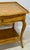 A beautifully crafted console table by Minton Spidell, this Regency-style console table features a hand-applied faux burl...