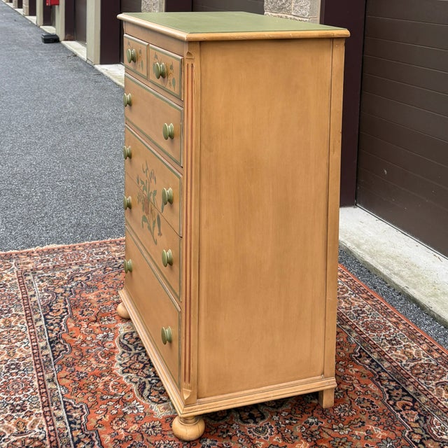 A mid 20th century Drexel paint decorated Country Farmhouse style 5 drawer highboy dresser in cream yellow and green with...