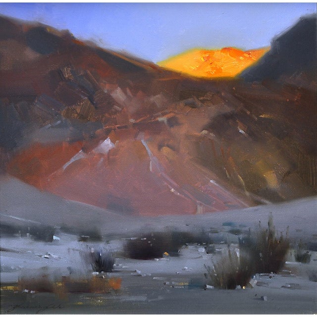 This artwork captures a serene desert landscape, where warm hues of gold and orange illuminate the mountain peaks against...