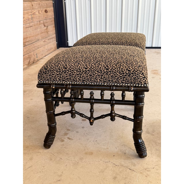 A striking pair of vintage faux bamboo fretwork ottomans, loaded with character and classic Regency flair. Each piece...
