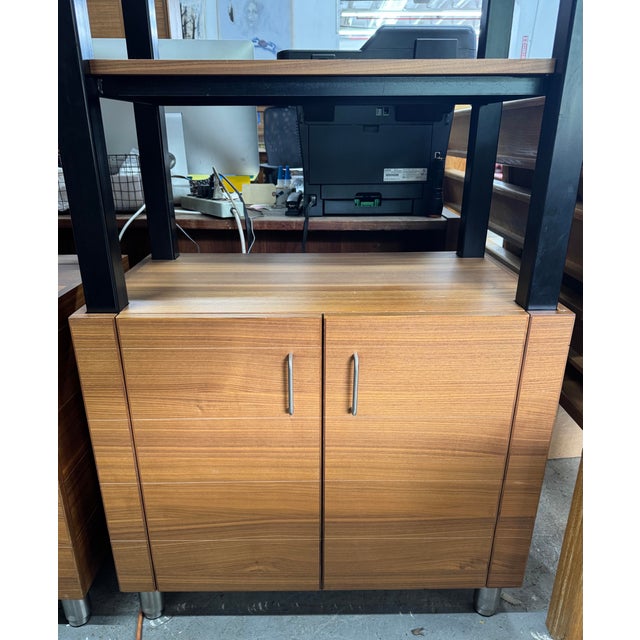 Impressive matching pair of tall industrial-style executive office shelving units, combining a sturdy black metal frame...
