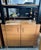 Impressive matching pair of tall industrial-style executive office shelving units, combining a sturdy black metal frame...