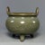 Classic Chinese official‑style celadon porcelain tripod incense burner. It features upright double handles, rounded...