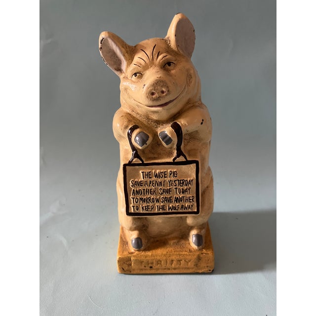 Delightfully charming, lovely 1900''s cast iron piggy bank. On the front pedestal the word "THRIFTY" to encourage young...