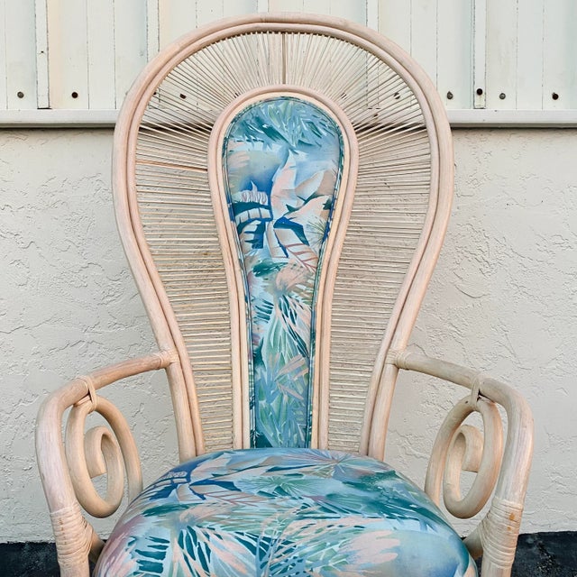 Vintage peacock style armchair features rattan, pencil reed details, bentwood swirl armrests and tropical blue upholstery....