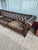 Distressed leather Chesterfield sofa has a deep brown finish with significant wear and patina on the seat cushions. This...