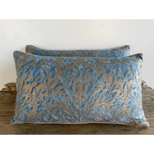 An elegant pair of decorative pillows crafted from luxurious Fortuny fabric, celebrated for its rich texture, historic...
