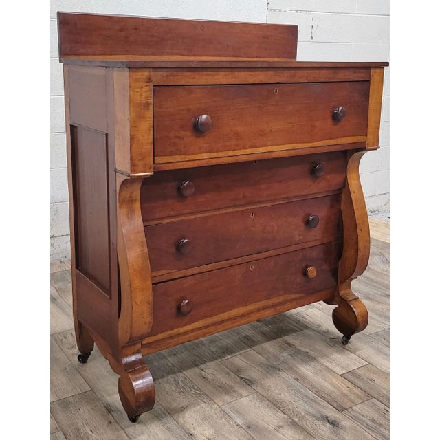 This is an absolutely beautiful antique 19th century American Empire four drawer chest or dresser. Wood appears to be...