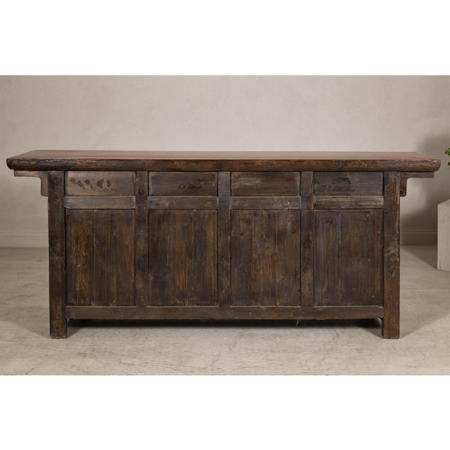 A late Qing Dynasty sideboard from the early 20th century in warm honey brown lacquer, blending functionality with refined...