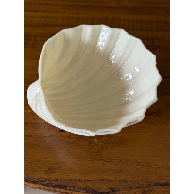 Delightful vintage Irish Belleek porcelain shell bowl featuring a gracefully molded seashell form raised on three...