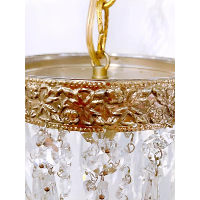 Italian layered chandelier with brass rim and 30% leaded U-drop crystal drops. It has 1 edison base sockets that holds up...