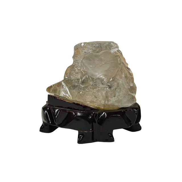 This exquisite hand-carved rock crystal quartz sculpture showcases a masterful play of light and organic form. The piece...
