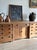 A long pine bench-counter built like furniture — two banks of four drawers flanking a center section with a single shallow...