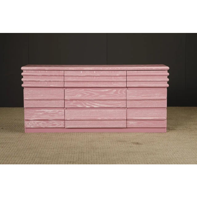 This striking 1980s Postmodern dresser has been fully refinished in a custom cerused pink finish with contrasting white...